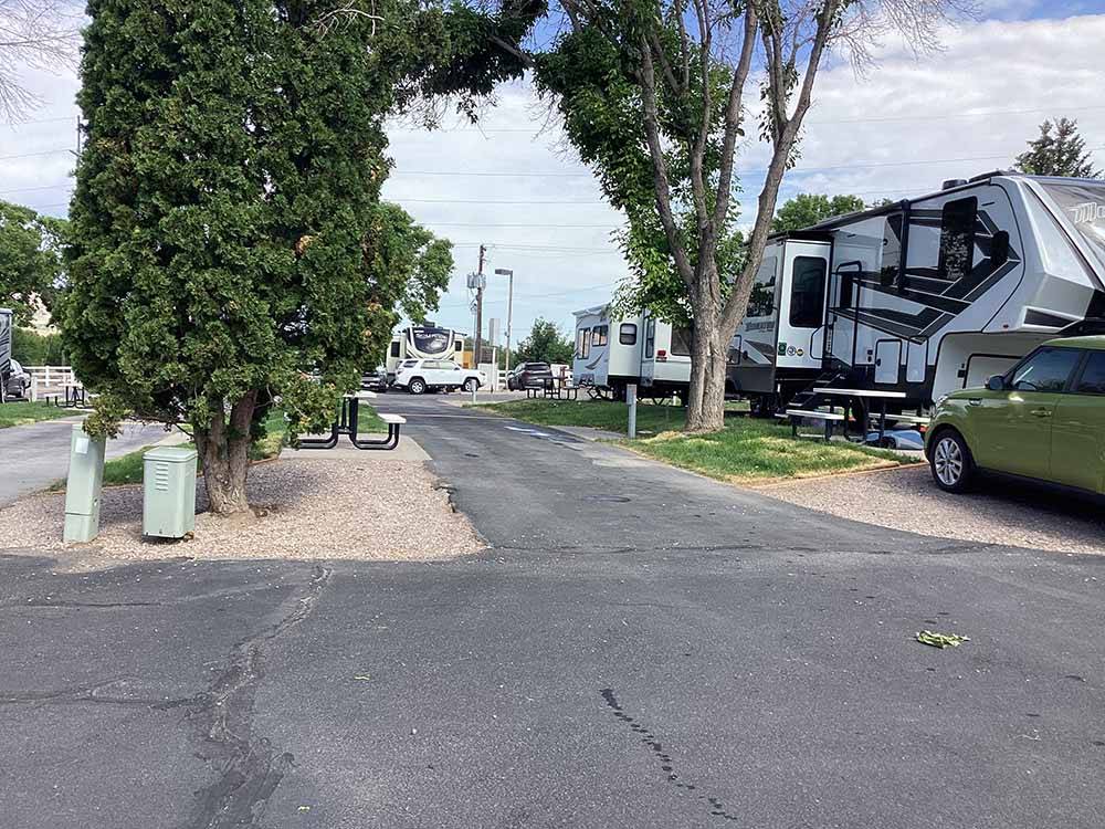 Fifth wheel trailer next to an empty site at COWBOY RV PARK