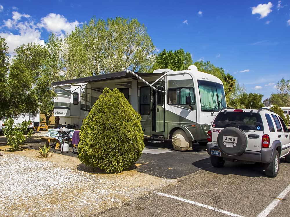 Class A Motorhome parked onsite at TWENTYNINE PALMS RESORT RV PARK AND COTTAGES