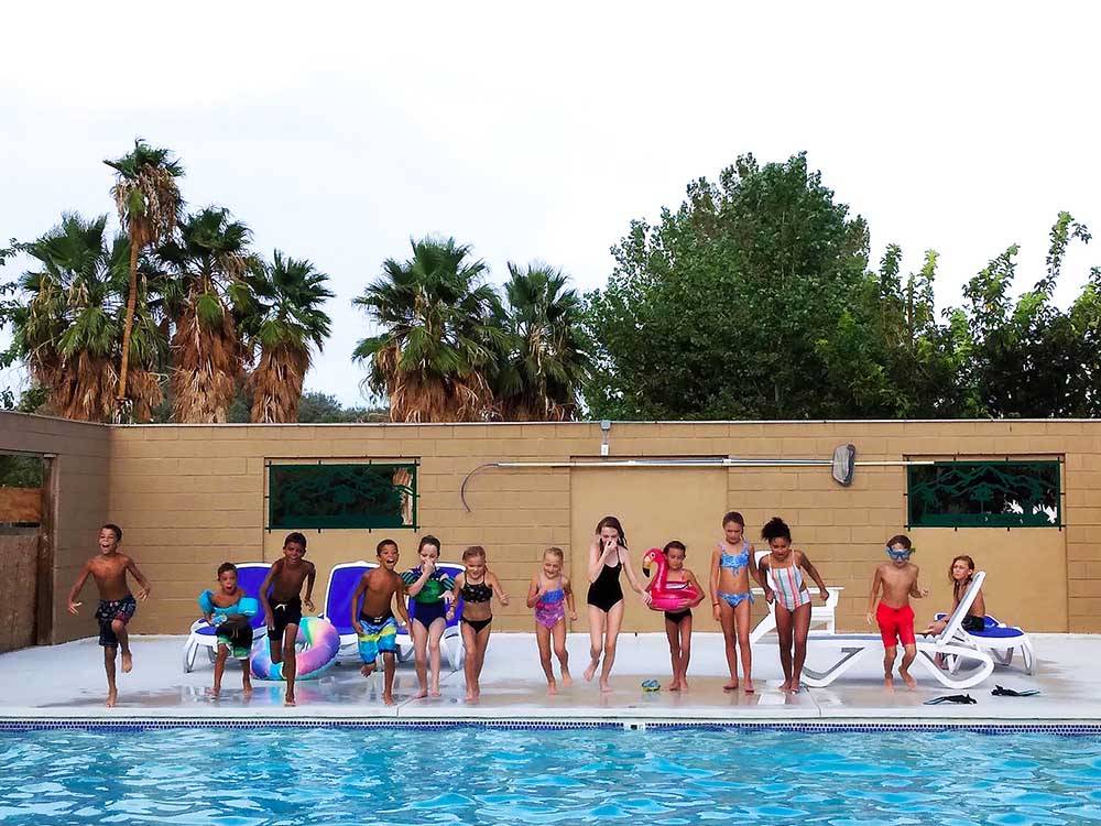 Kids ready to jump in the pool at TWENTYNINE PALMS RESORT RV PARK AND COTTAGES