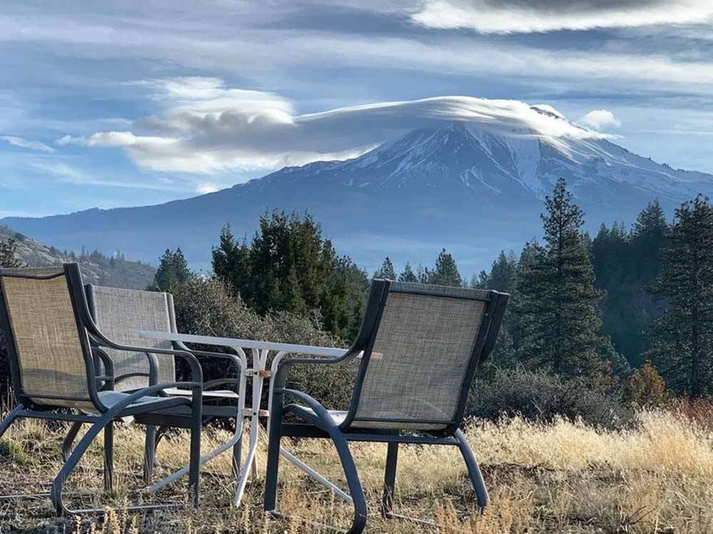 A table and chairs looking at a mountain at TRAILER LANE CAMPGROUND
