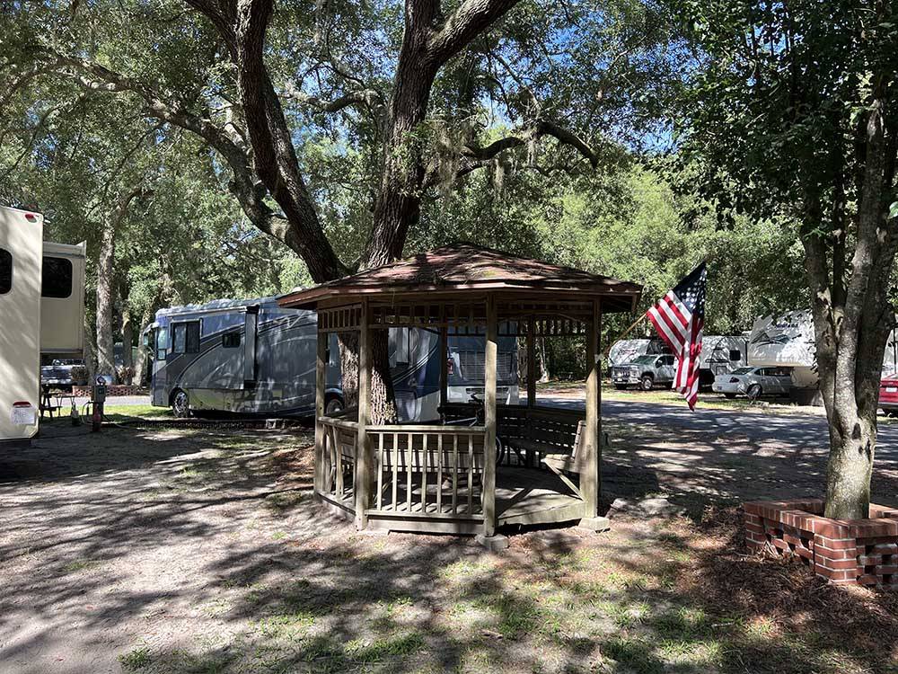 Gazebo with motorhomes in campsites at KELLY'S COUNTRYSIDE RV PARK
