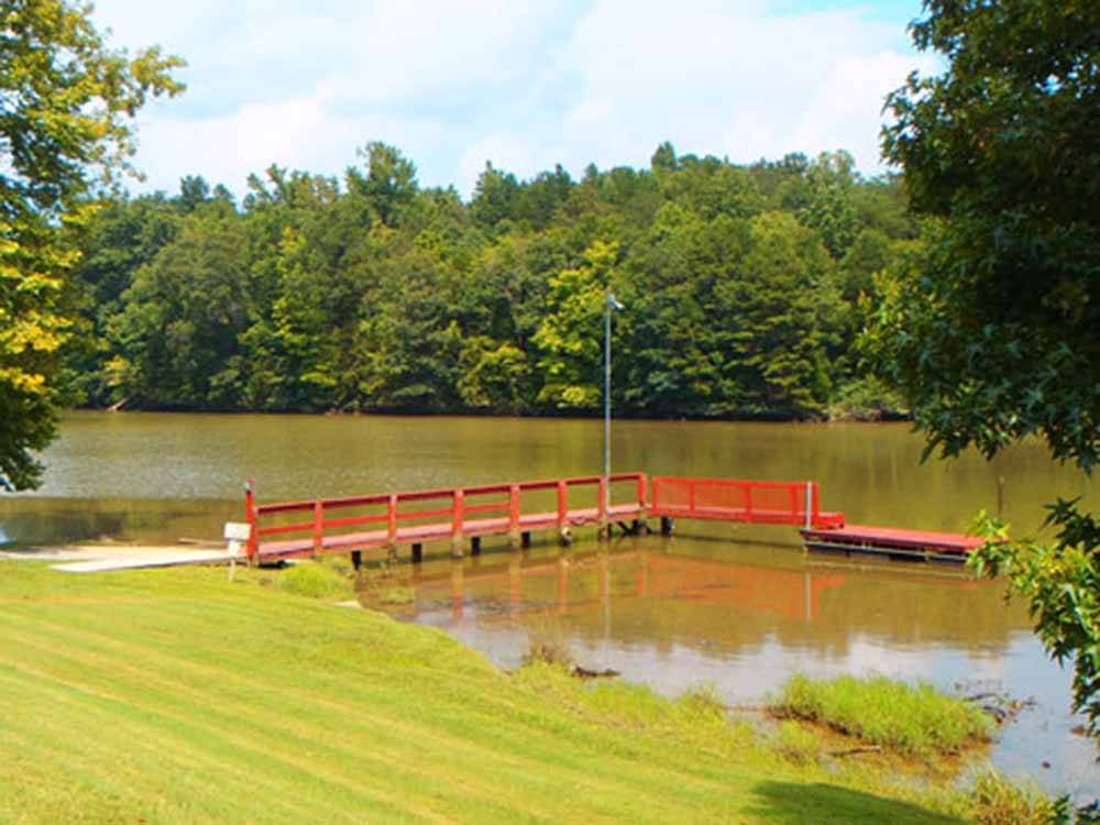 The red dock on the lake at SOARING EAGLE CAMPGROUND & RV PARK