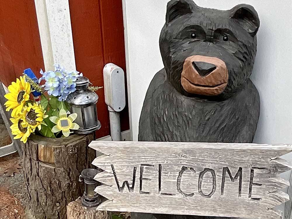 Wooden bear statue and welcome sign at YORK BEACH CAMPER PARK