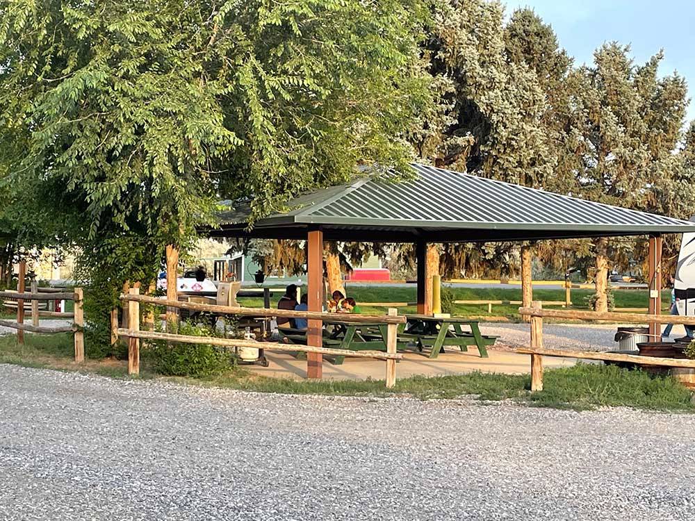 Covered picnic area surrounded by trees at EAGLE RV PARK & CAMPGROUND