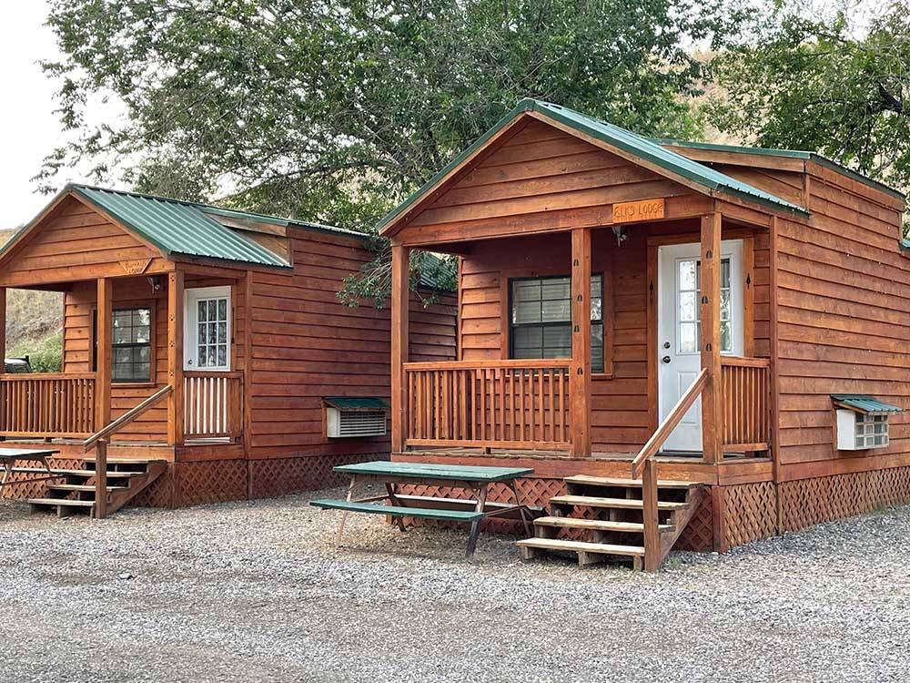 Wooden rental cabins with decks at EAGLE RV PARK & CAMPGROUND