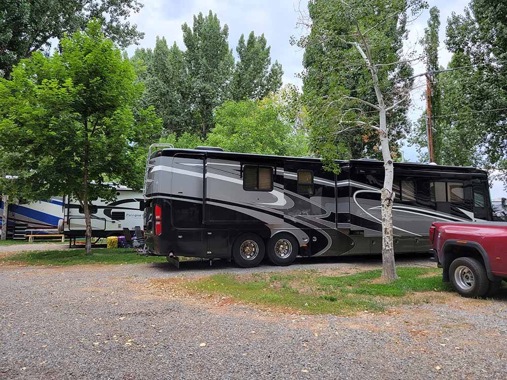 A motorhome in a gravel RV site at FOSSIL VALLEY RV PARK