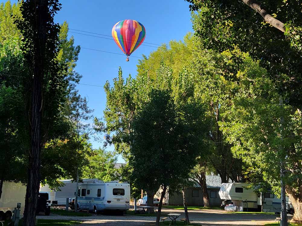 A hot air balloon over the campsites at FOSSIL VALLEY RV PARK