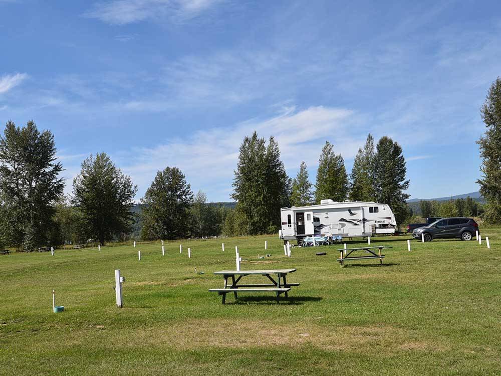 A view of the empty grassy sites at AIRPORT INN MOTEL AND RV PARK