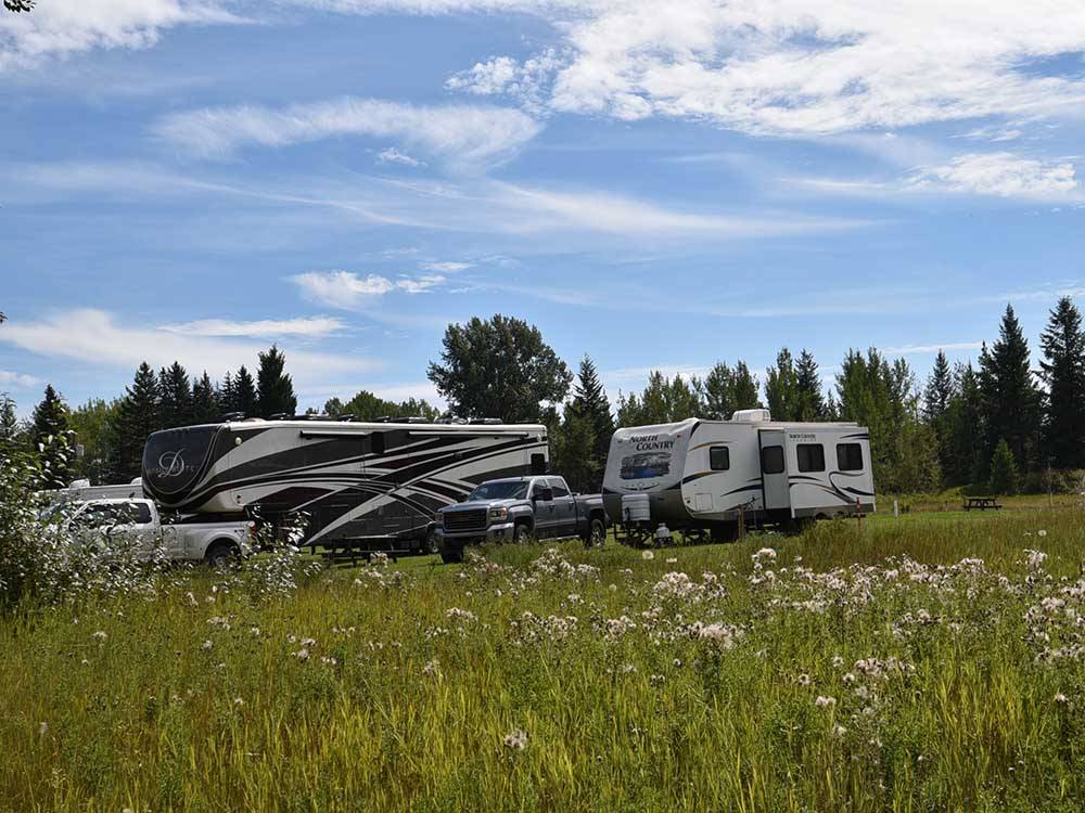 A fifth wheel and travel trailer parked at AIRPORT INN MOTEL AND RV PARK