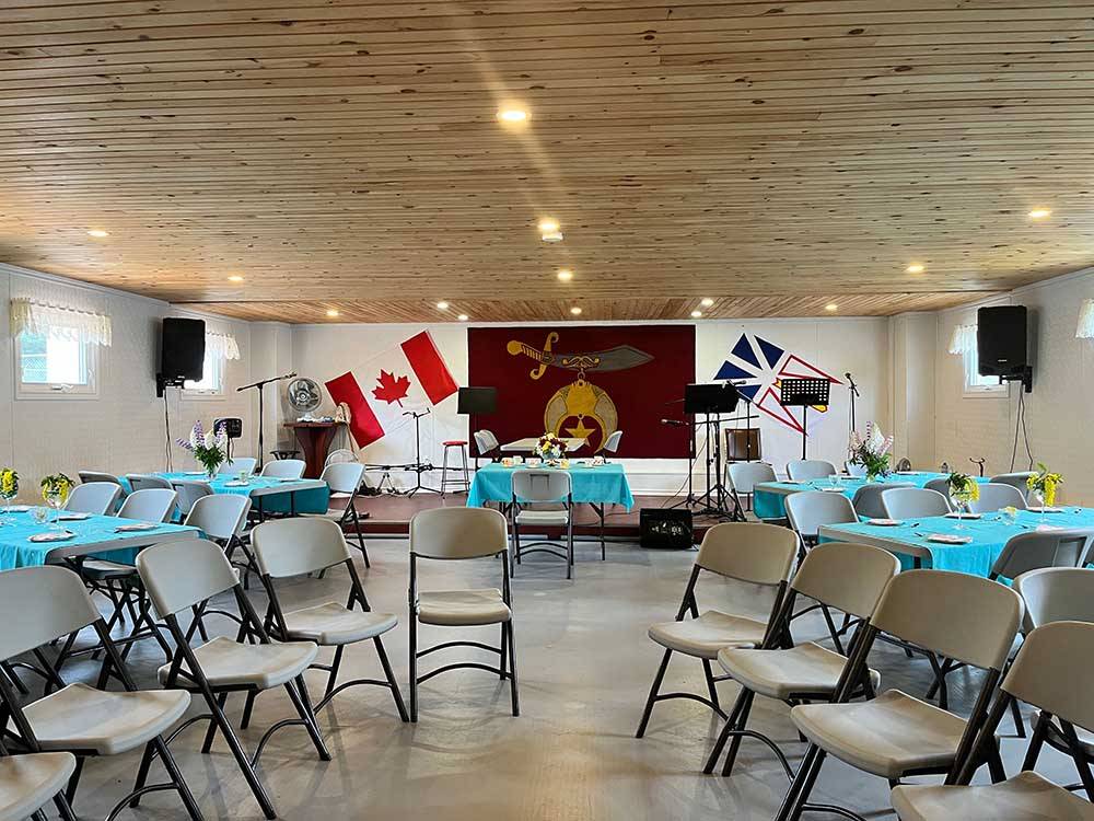 Chairs and tables in the community room at HAROLD W. DUFFETT SHRINERS RV PARK