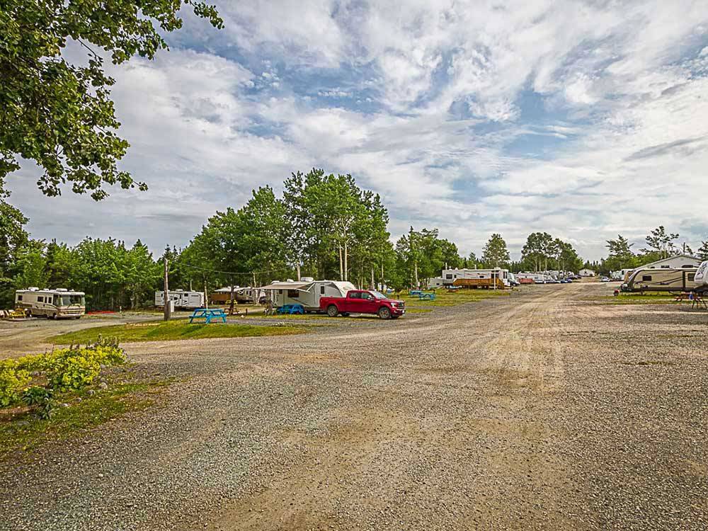 A gravel road next to back in RV sites at HAROLD W. DUFFETT SHRINERS RV PARK