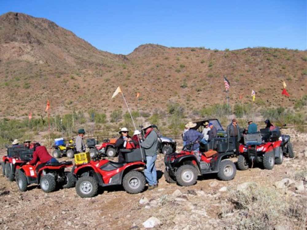 A group of people riding ATVs nearby at BLACK ROCK RV VILLAGE