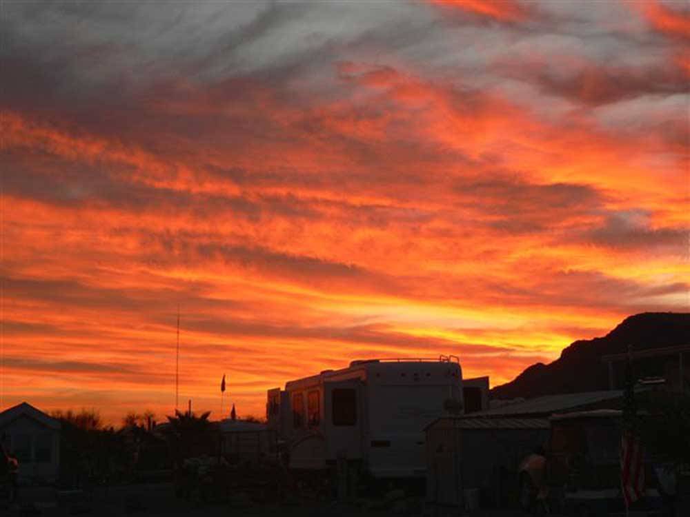 A motorhome parked under the beautiful sunset sky at BLACK ROCK RV VILLAGE