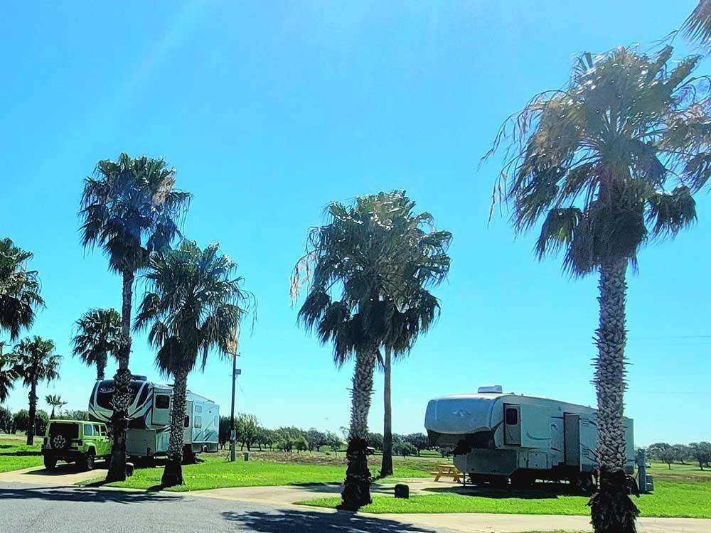 Two fifth wheels parked in paved sites at RIVER BEND RESORT & GOLF CLUB