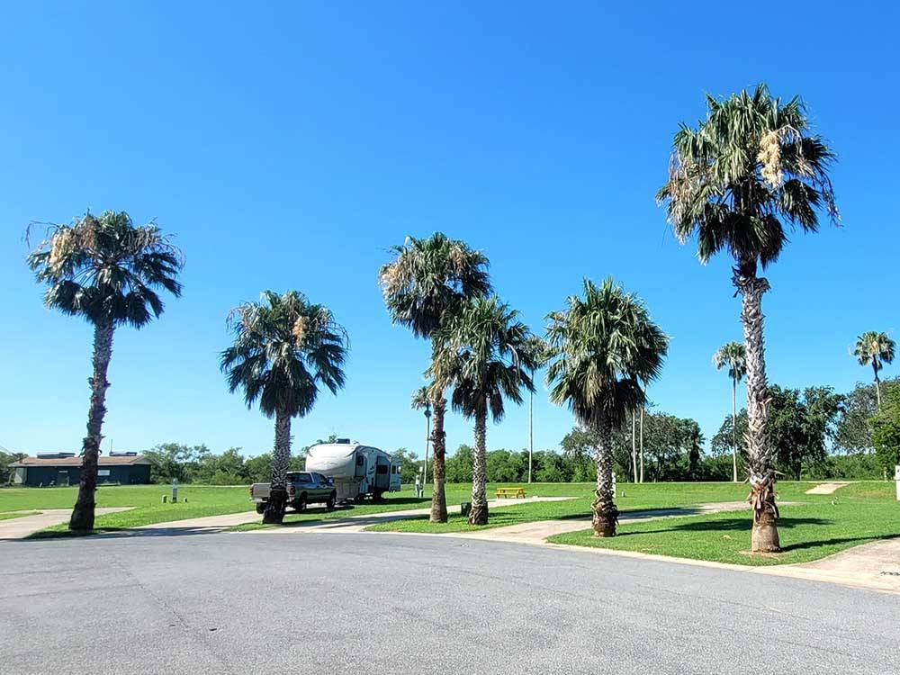 A row of empty sites next to a parked travel trailer at RIVER BEND RESORT & GOLF CLUB