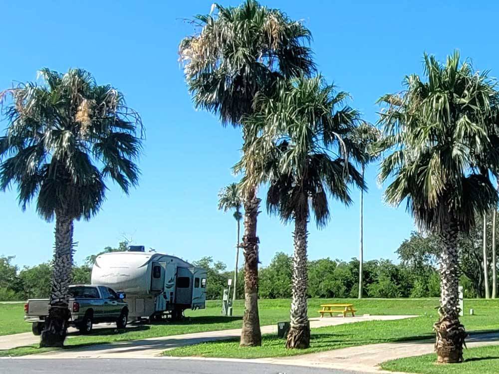 A travel trailer parked in a paved site at RIVER BEND RESORT & GOLF CLUB