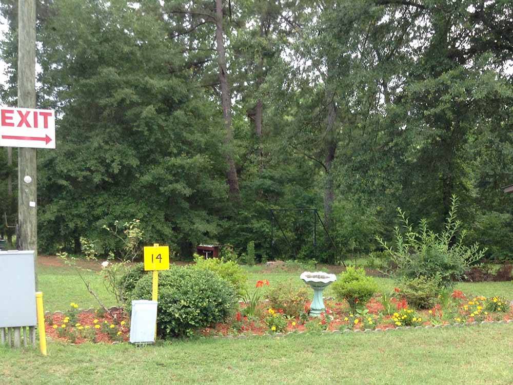 A bird bath in a group of flowers at L & D RV PARK