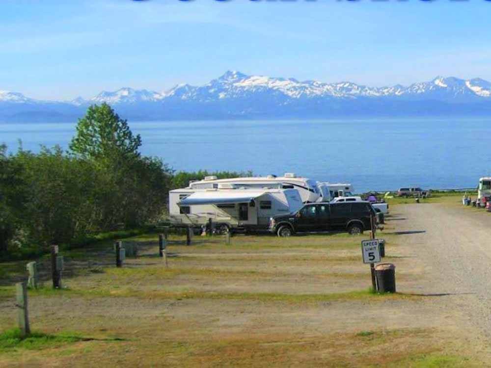 A row of RVs with mountains in the background at OCEAN SHORES RV PARK  RESORT