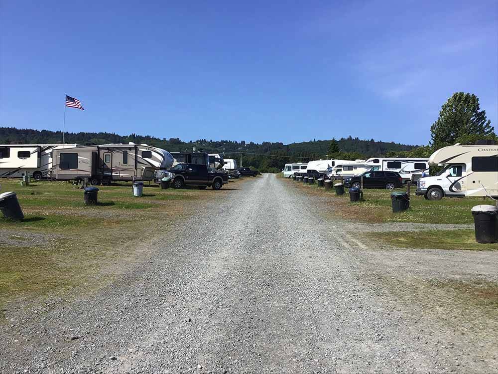 A gravel road with RV sites on both side at OCEAN SHORES RV PARK & RESORT