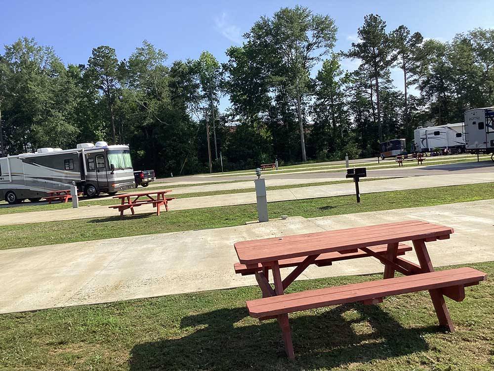 A few empty RV sites with benches at DOTHAN RV PARK