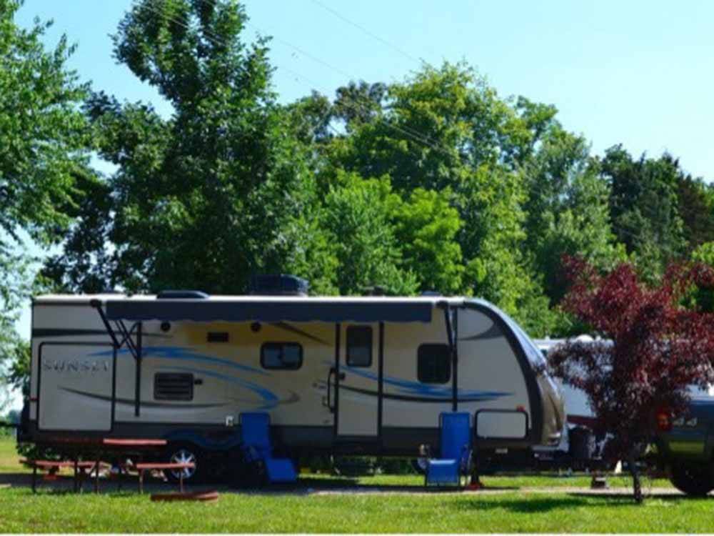 A travel trailer parked in a RV site at JELLYSTONE PARK AT MAMMOTH CAVE