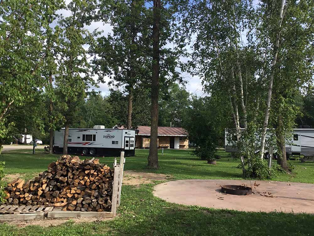 A large fire pit with firewood at ROYAL OAKS RV PARK
