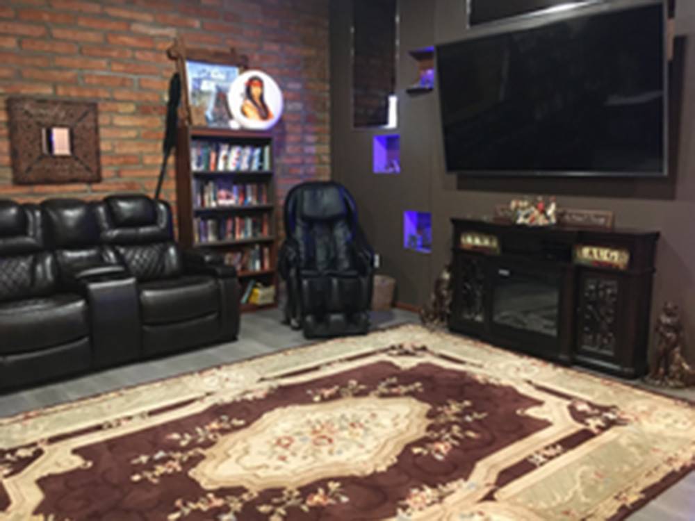 Lounge area with big screen TV and couches at Lifestyle RV Resort