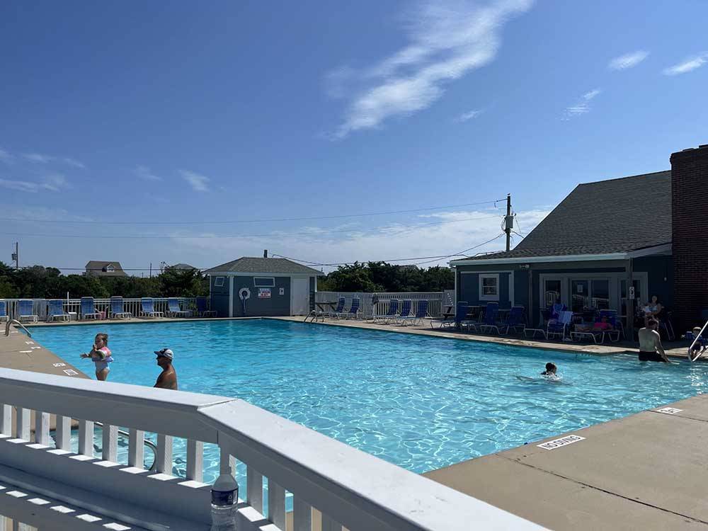 Guest enjoying the swimming pool at CAMP HATTERAS RV RESORT & CAMPGROUND