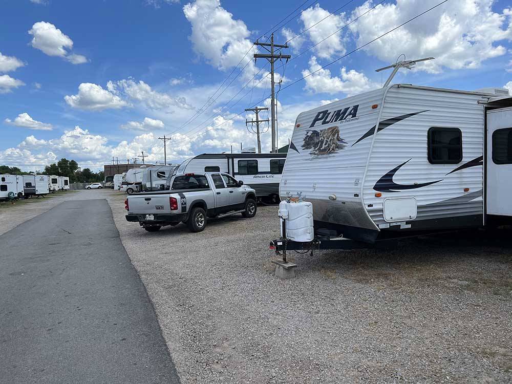 A truck and trailer in a RV site at OVERLAND RV PARK