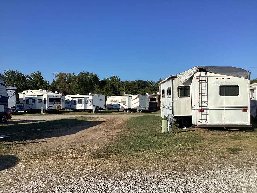 An empty gravel site next to a parked trailer at OVERLAND RV PARK