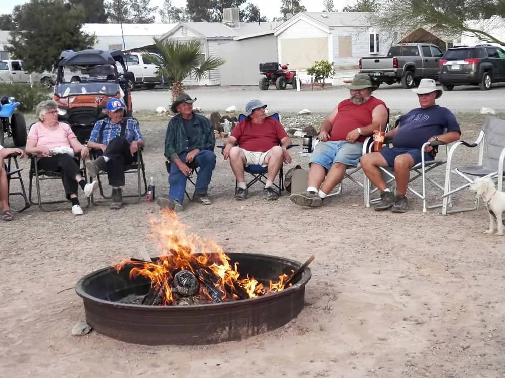 Campers sitting around a fire pit