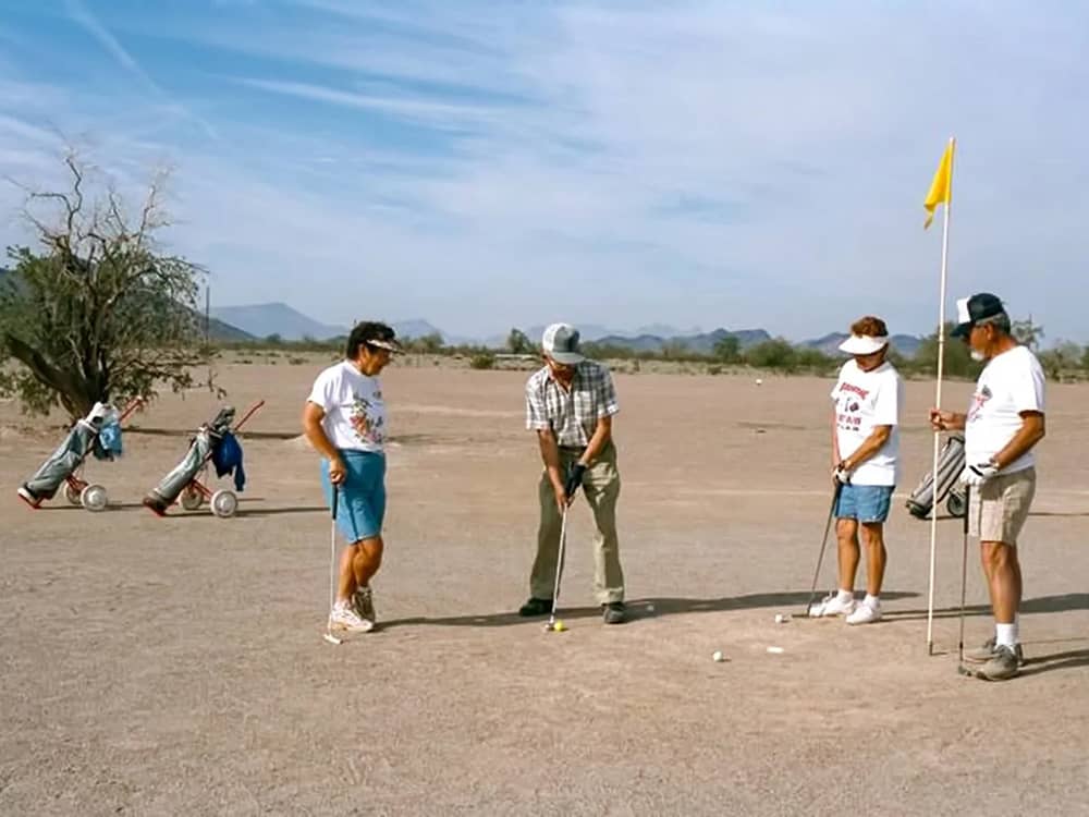 Two couples playing golf