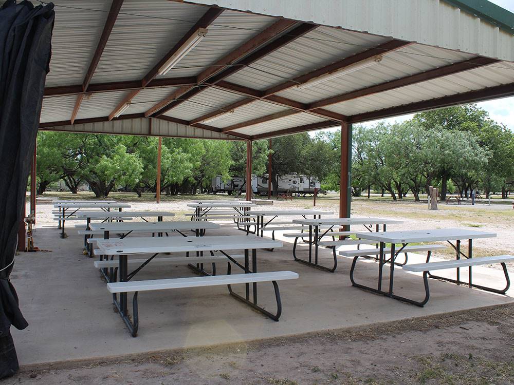 Picnic benches under the large pavilion at FORT CLARK SPRINGS RV PARK