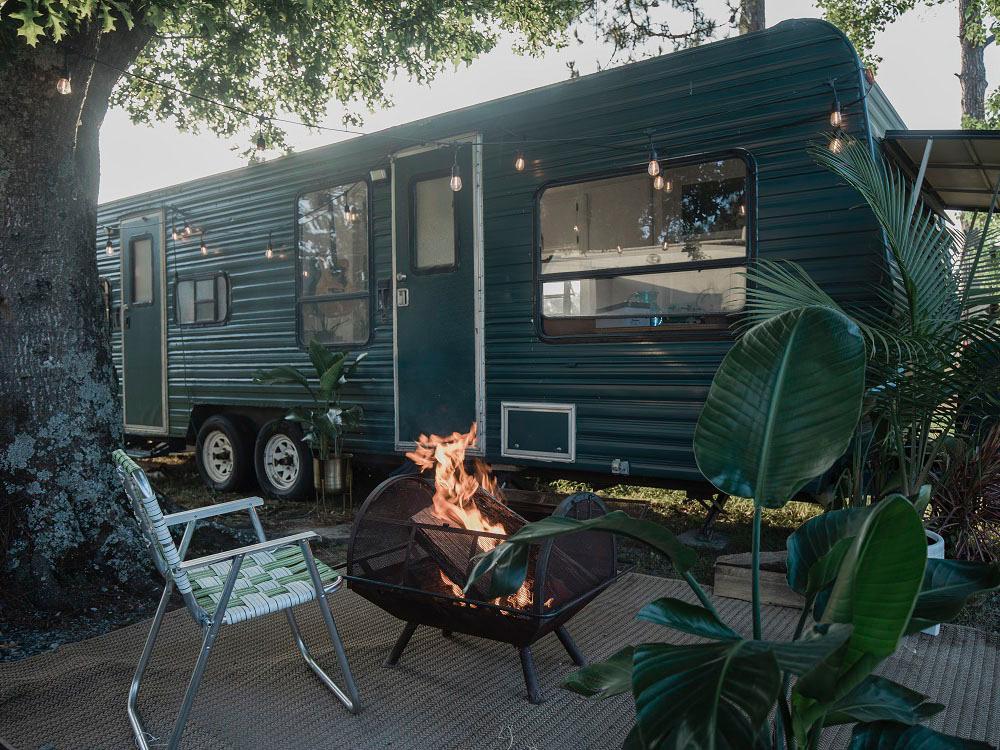 Travel trailer parked at site with a fire at THE OUACHITA RV PARK