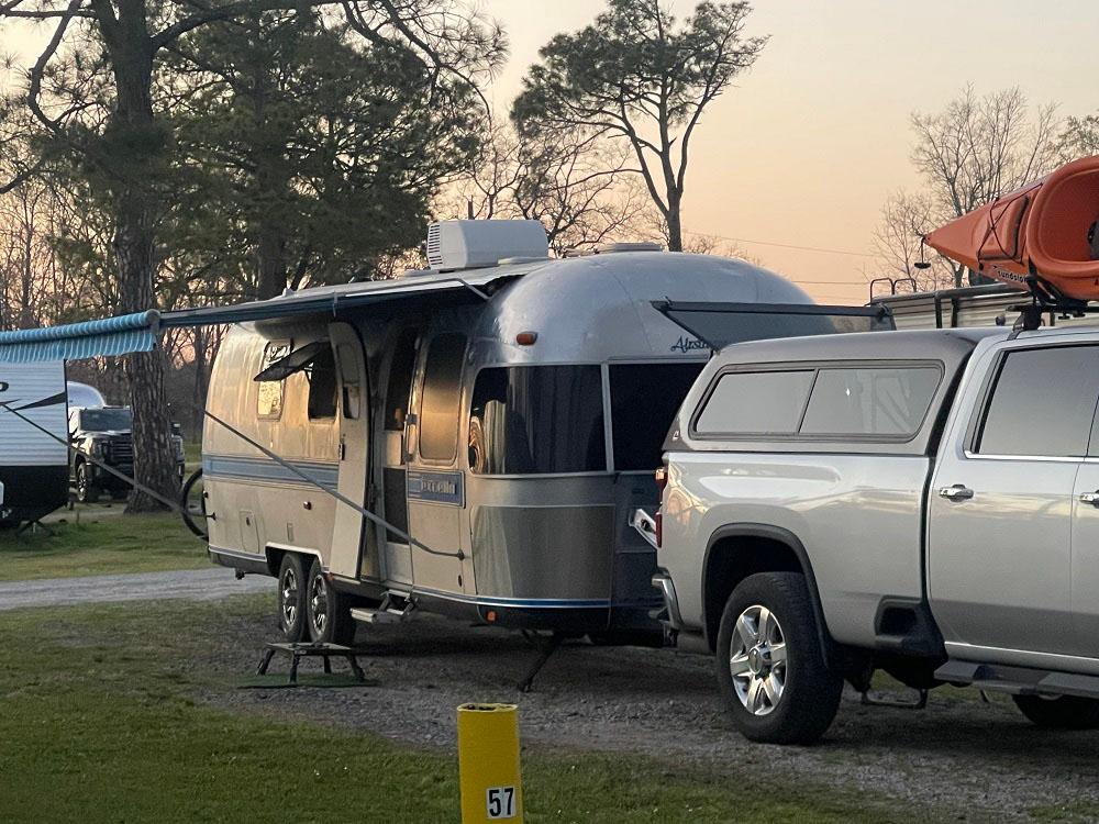 An airstream parked at a site at THE OUACHITA RV PARK