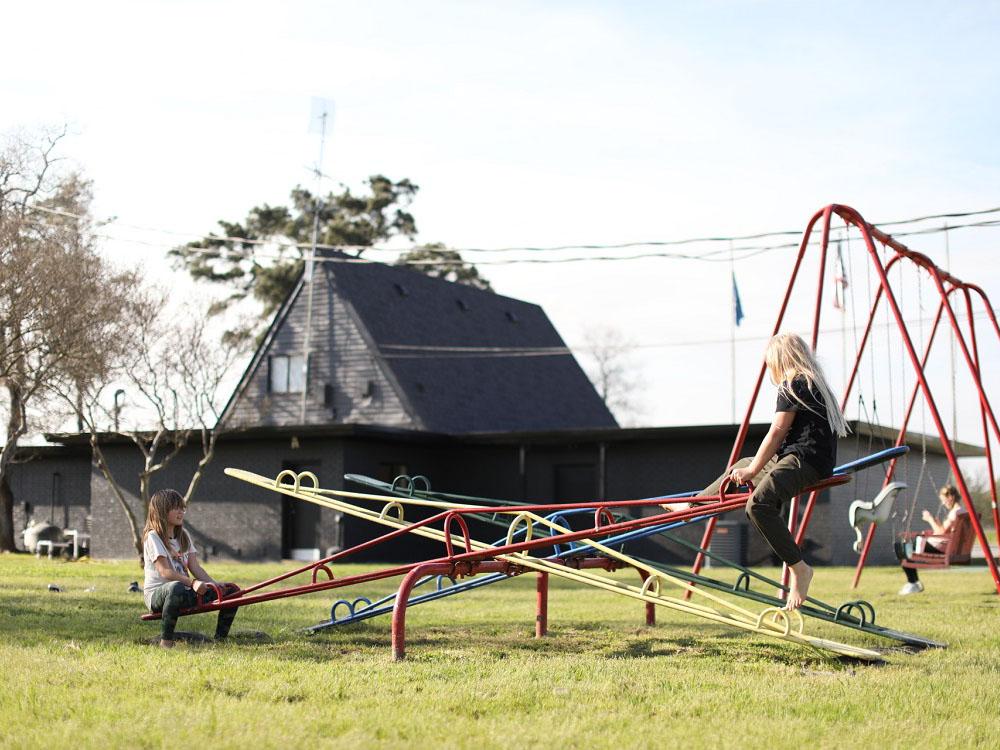 Children playing on the seesaw at THE OUACHITA RV PARK