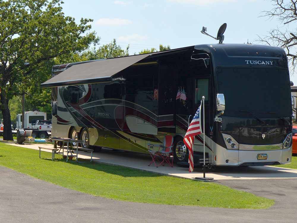 Motorhome in a paved RV site at MOCKINGBIRD HILL RV PARK