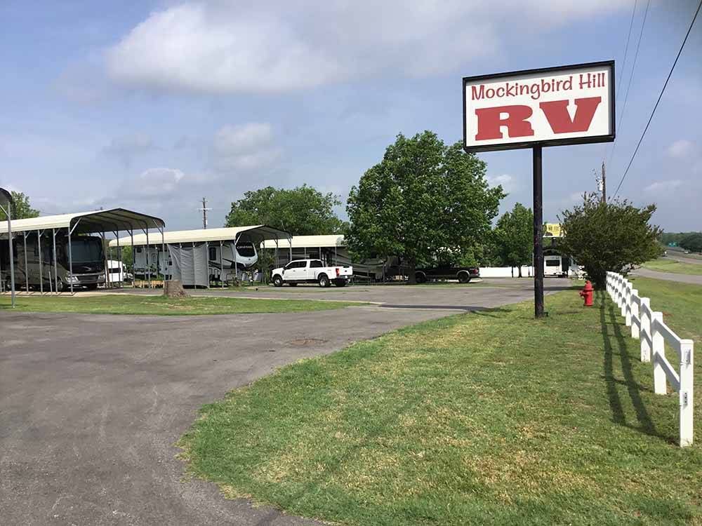 The front entrance sign and road at MOCKINGBIRD HILL RV PARK