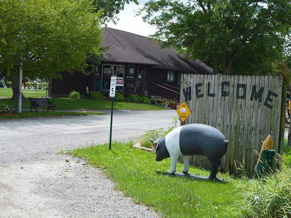 Painted pig statue in front of sign at INTERSTATE RV PARK