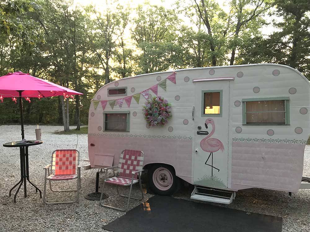 Vintage trailer adorned with a pink flamingo at LAZY DAY CAMPGROUND