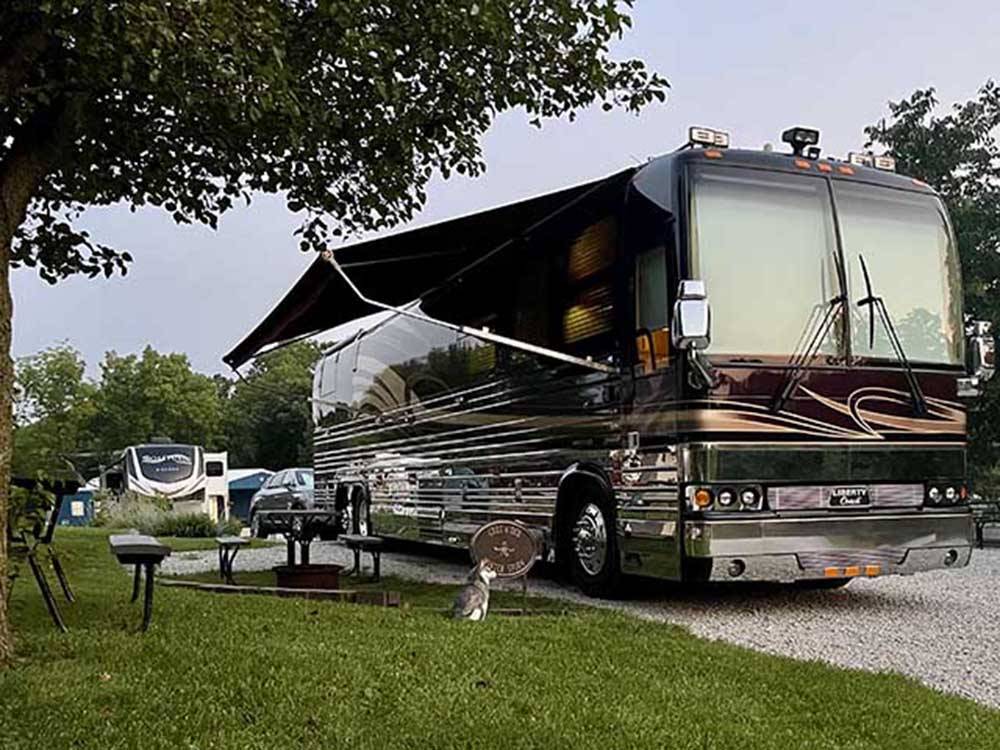 A motorhome in an RV site with it's awning out at LAZY DAY CAMPGROUND