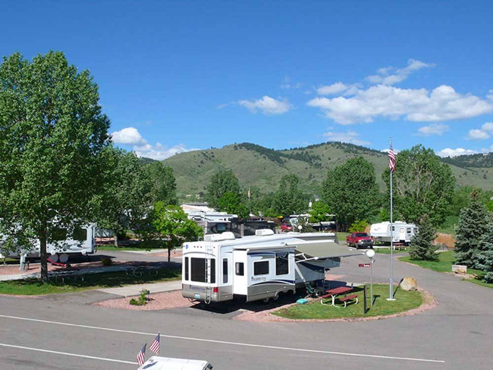 Trailers camping with low hills in the background at DAKOTA RIDGE RV RESORT