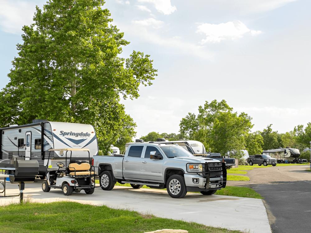 RV and golf cart parked in a site