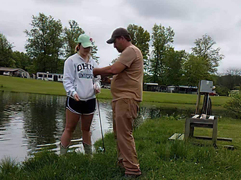 A father and daughter fishing at TOWN & COUNTRY CAMP RESORT