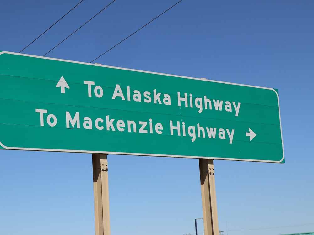 The road sign to the Alaska and Mackenzie highways at SHERK'S RV PARK