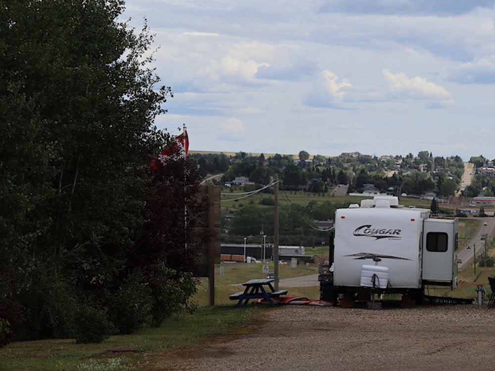 Cougar trailer in spacious RV site with picnic bench at NORTHERN LIGHTS RV PARK