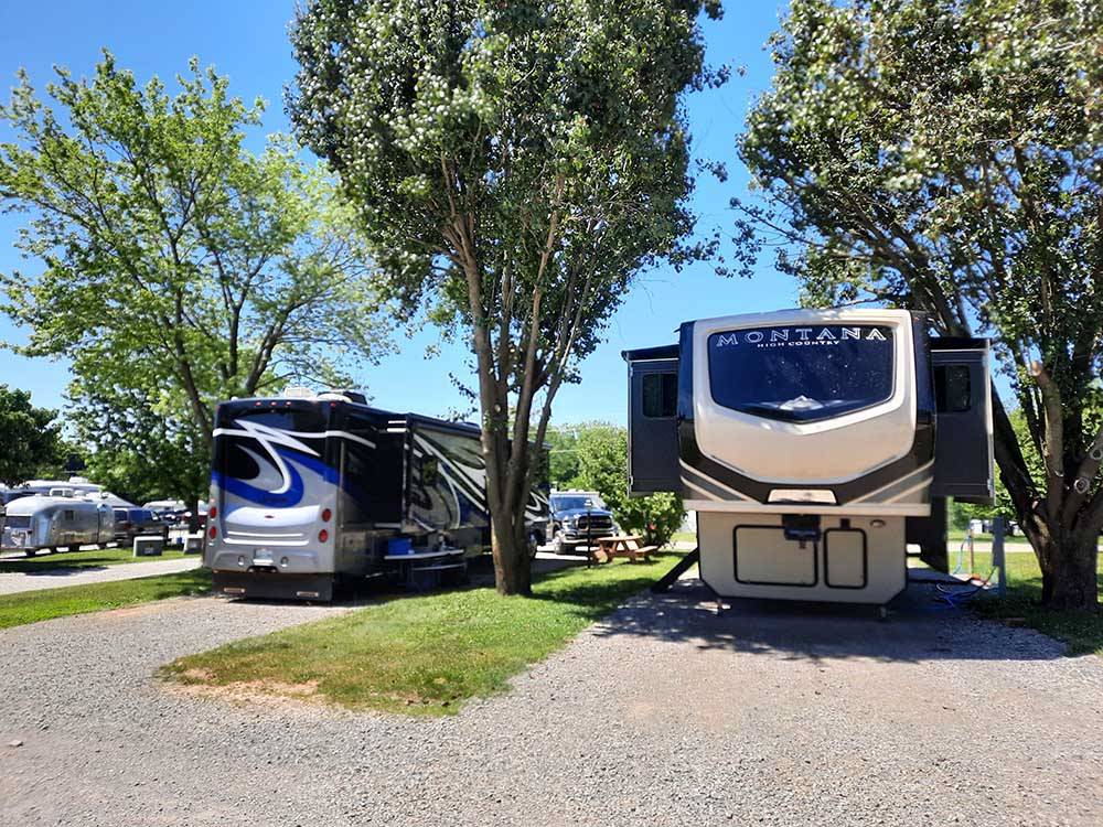 Motorhomes parked in gravel sites at DADS BLUEGRASS CAMPGROUND