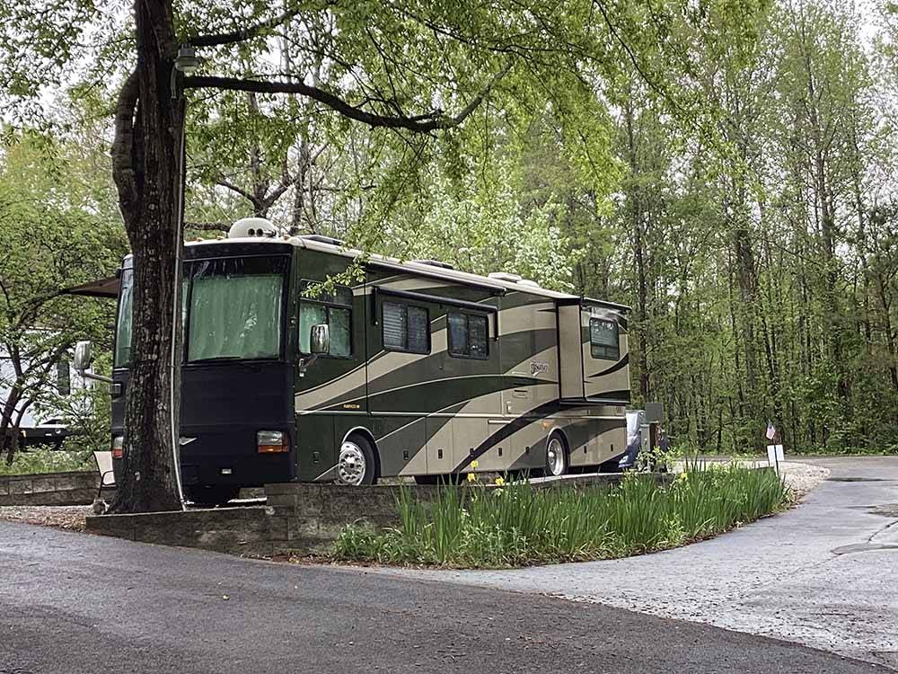 A Class A motorhome in an RV site at CAMPGROUND AT BARNES CROSSING