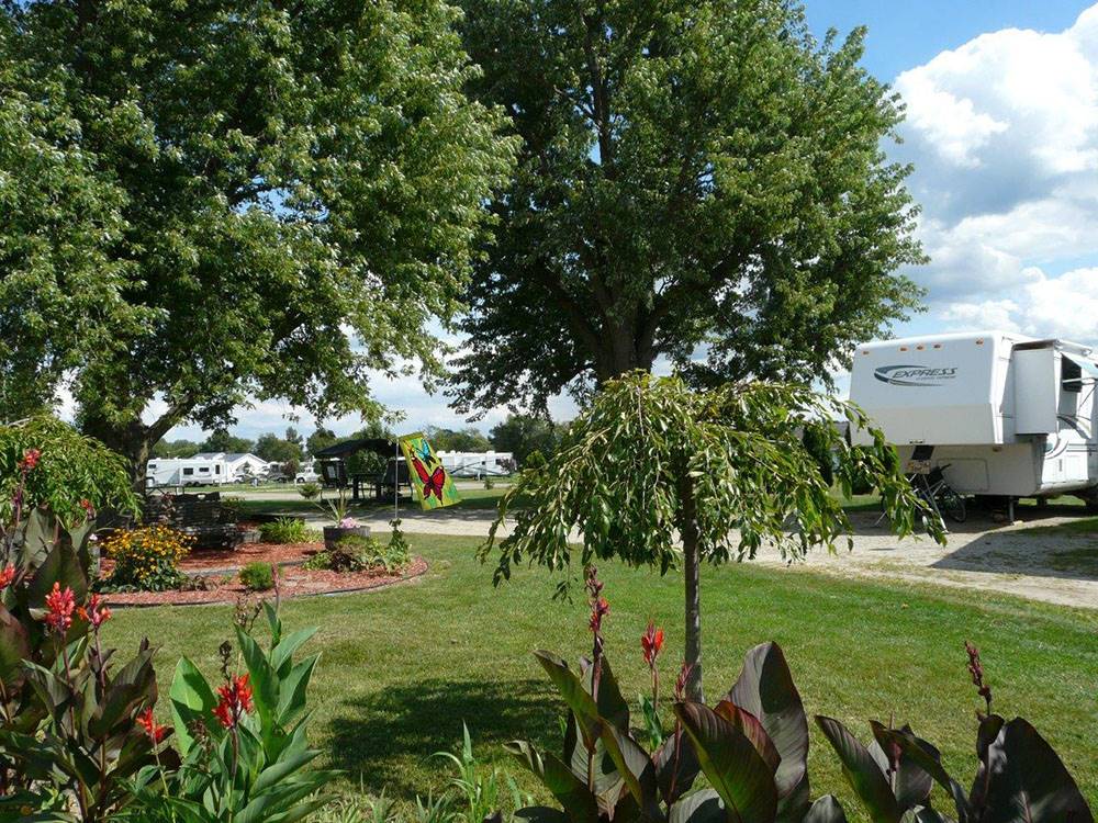 A RV parked next to a flower bed at SHIPSHEWANA CAMPGROUND SOUTH PARK