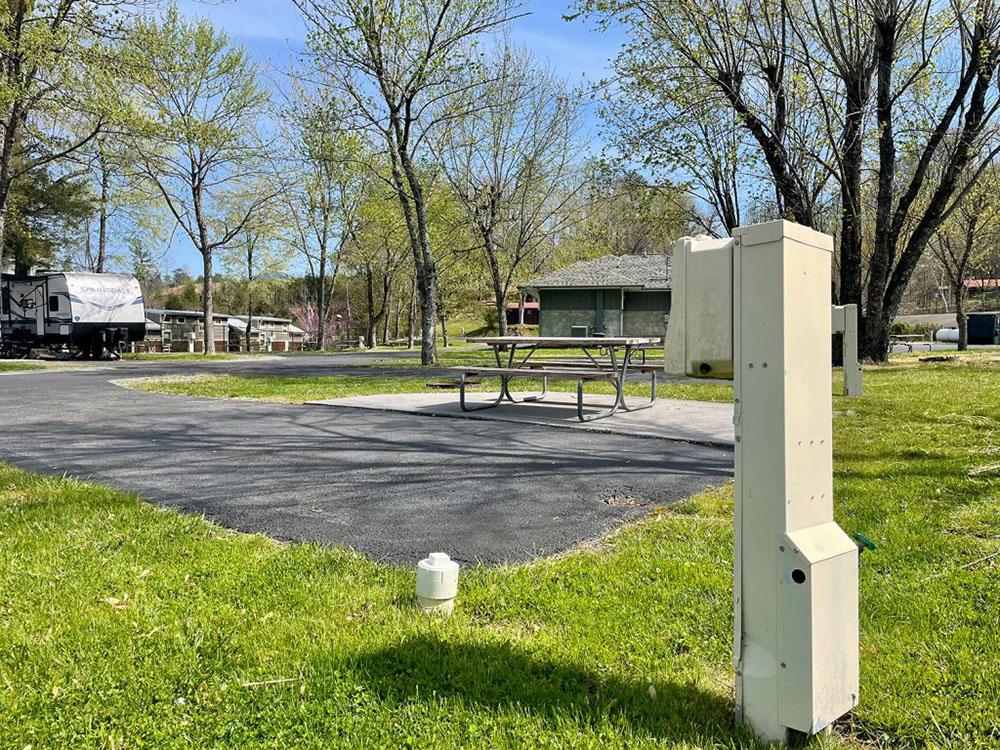 Paved site with picnic table at FOOTHILLS RV PARK & CABINS